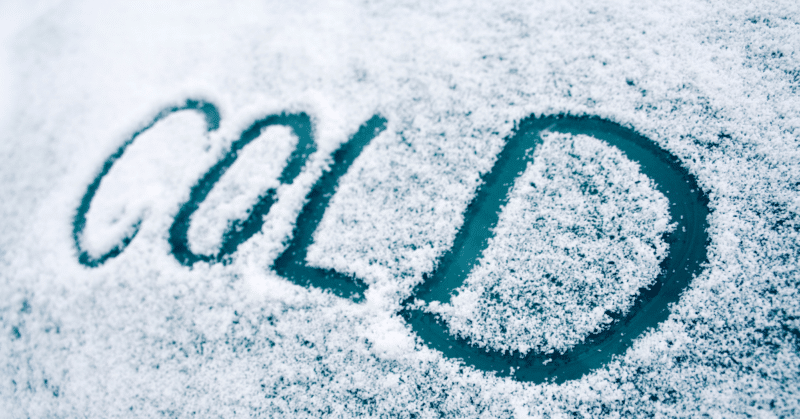cold written in the flurries on a window