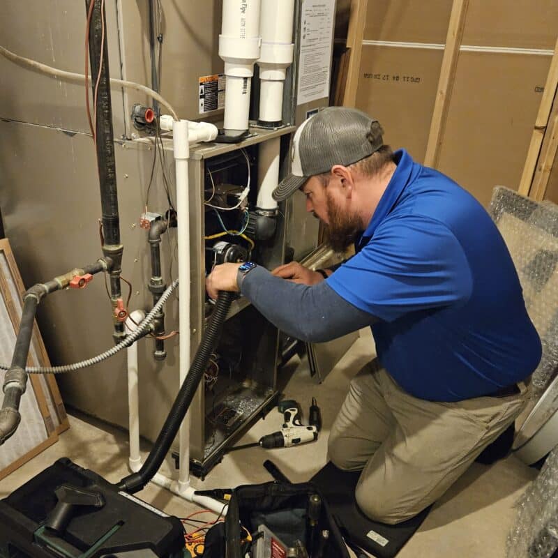 Technition performing Furnace maintenance on residential furnace
