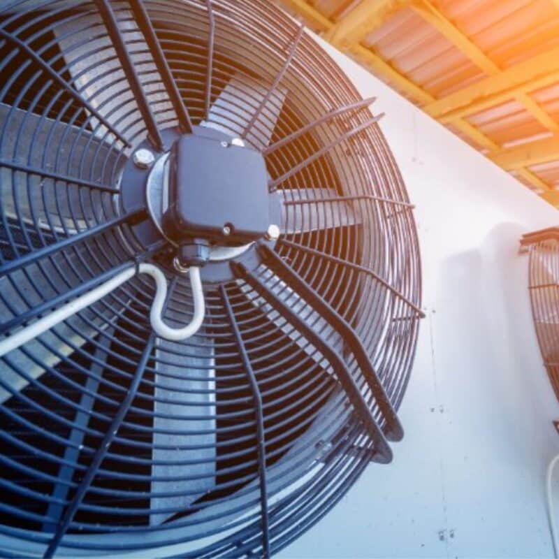 Close up of an AC unit running on a summer day