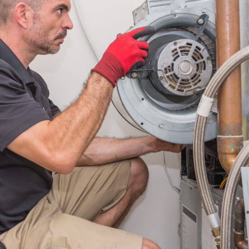 worker repairing an AC unit