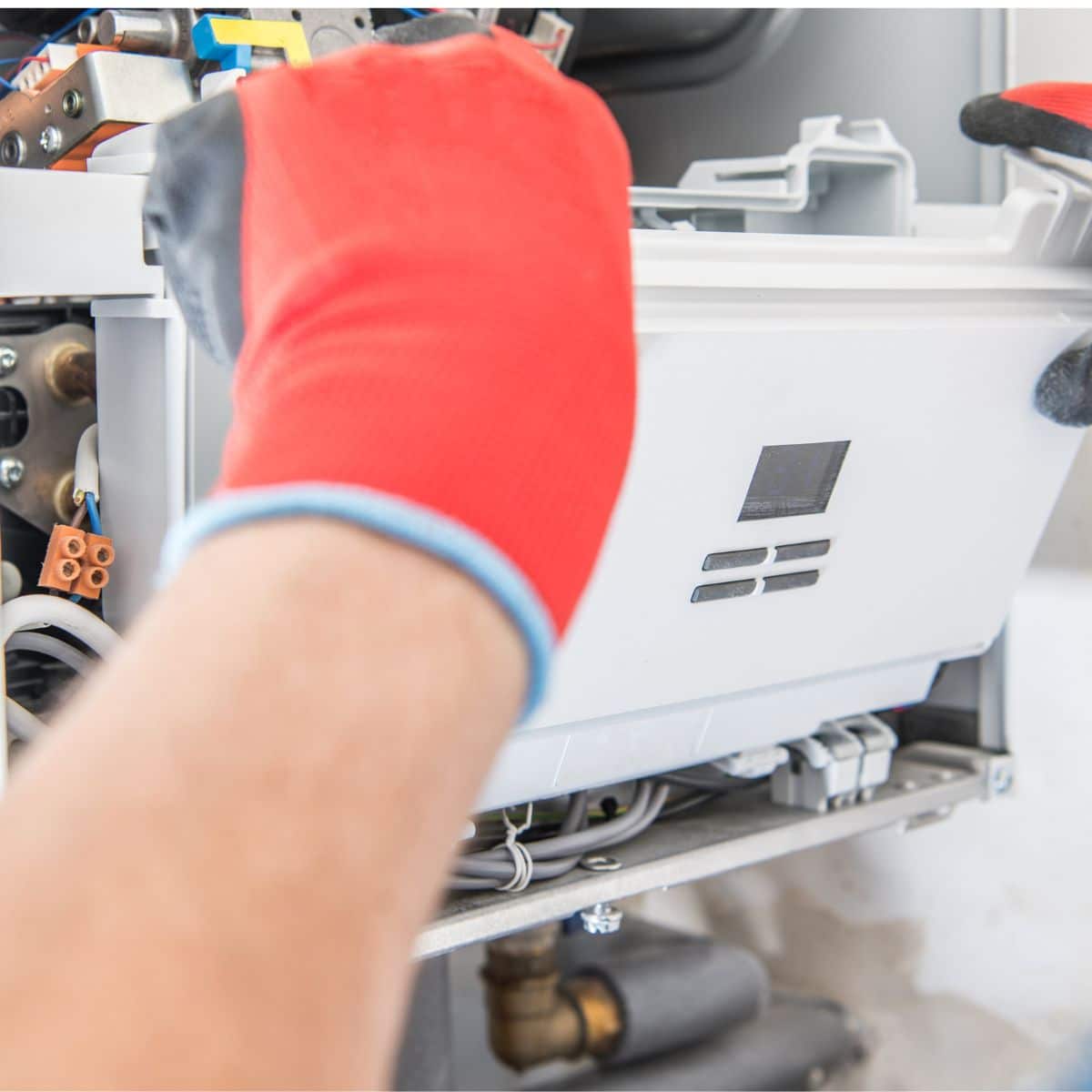 close up of a worker hands repairing an AC unit