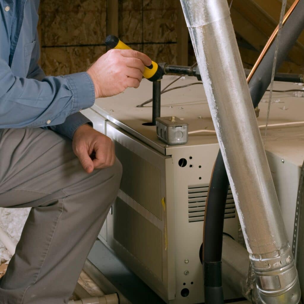 furnace being installed at a Gilberts' home attic