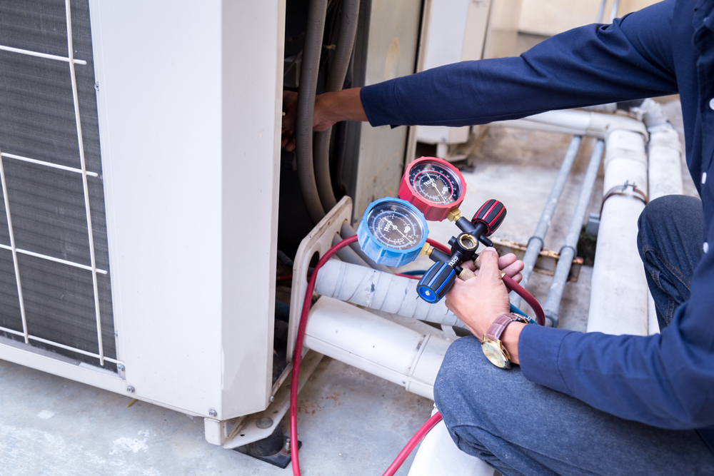Technician Diagnosing AC Unit